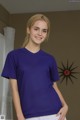 A woman in a purple shirt is posing for a picture.